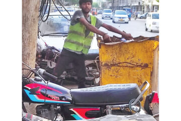 a sanitary worker picks up garbage without wearing gloves and face mask avoiding simple safety measures have caused skin and breathing disorders among sanitary workers photo razzak abro express